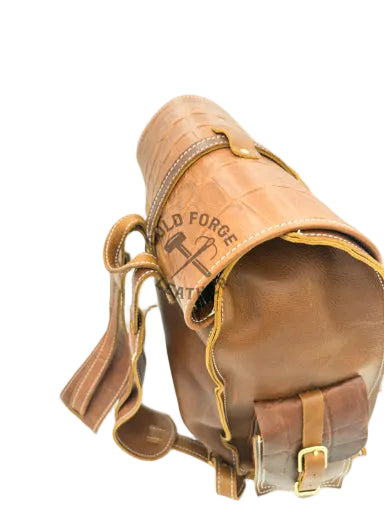 A brown leather shoulder bag with a crocodile-embossed texture, featuring a matching leather strap, brass buckle.
