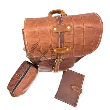 A brown backpack with a matching pouch and wallet, displayed on a reflective white surface. 