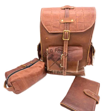A brown crocodile-embossed leather backpack set with a matching zippered pouch and wallet, displayed on a white background.