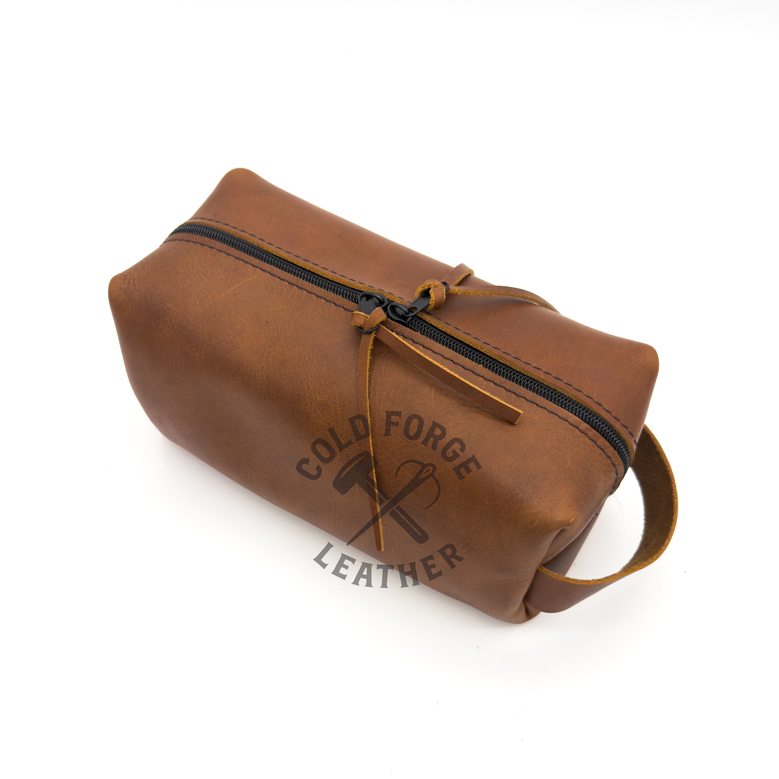 A brown leather zippered pouch with a top handle, shown on a white background. 